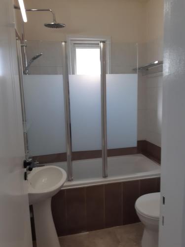 a bathroom with a shower and a sink and a toilet at Beautiful apartment near beach in Larnaca in Scala