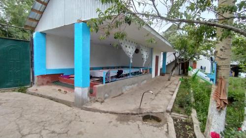 a house with a blue and white at Panorama in Arslanbob