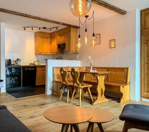 a kitchen and living room with a table and chairs at Ferienwohnung in den Bergen mit grosser Terrasse in Bivio