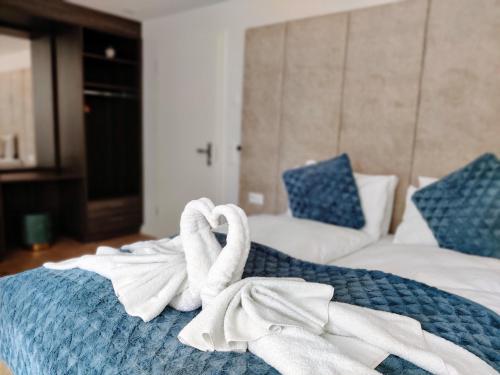 a bed with two towels on top of it at Hotel Sonne Interlaken-Matten in Interlaken