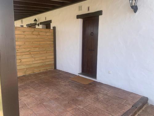 a room with a wooden door and a tile floor at Apartamentos Villa Pirata Tarifa in Tarifa