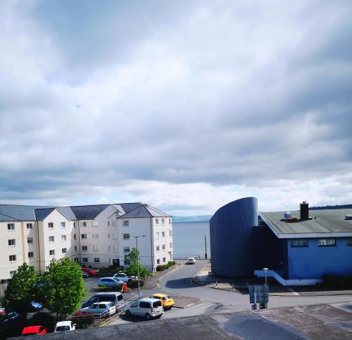 arial view of a city with cars parked in a parking lot at The Snug in Dunoon