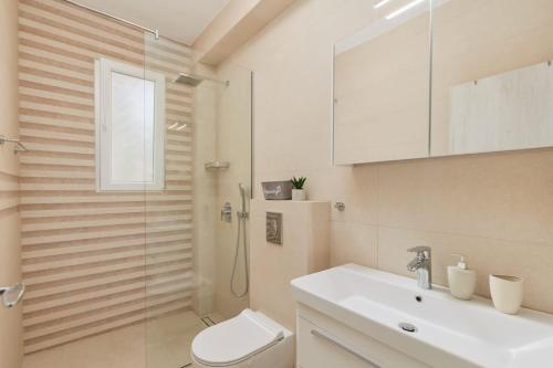 a bathroom with a shower and a toilet and a sink at Petrovic apartmani in Tivat