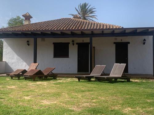 a group of chairs in front of a house at Apartamentos Villa Pirata Tarifa in Tarifa