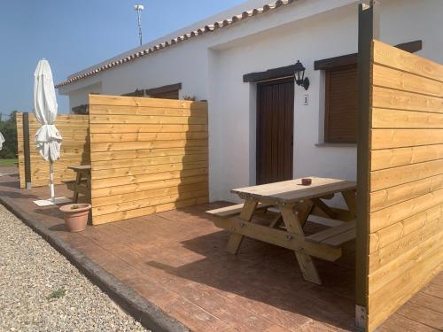 a wooden picnic table on a patio next to a building at Apartamentos Villa Pirata Tarifa in Tarifa