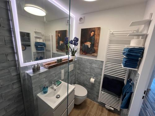 a bathroom with a sink and a toilet and a mirror at Seemannsbraut in Kellenhusen