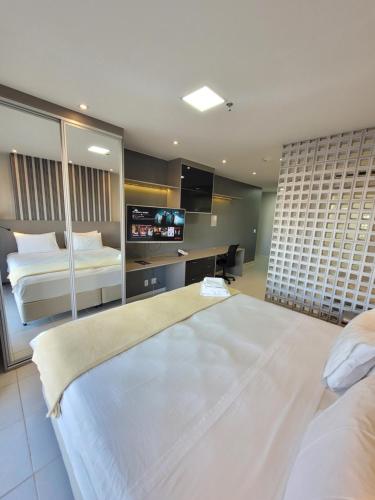 a hotel room with a large bed and a flat screen tv at Vision Executive Esplanada in Brasilia