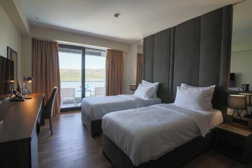 מיטה או מיטות בחדר ב-Glorius Hotel