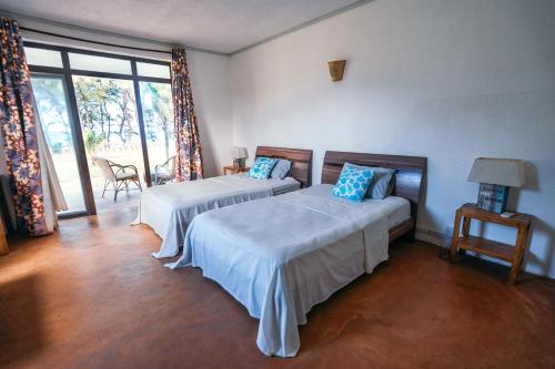Ένα ή περισσότερα κρεβάτια σε δωμάτιο στο Gravier beach house