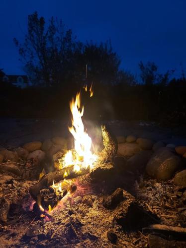 a fire burns in the dirt at night at Garragh Mhor in Oban