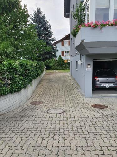 a brick street with a car parked next to a building at Studio direkt am Bodensee in Thal