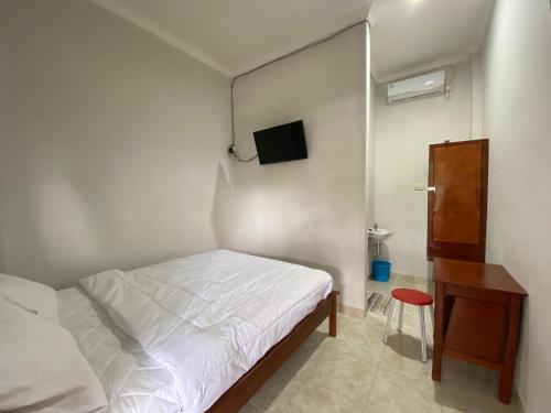 Ένα ή περισσότερα κρεβάτια σε δωμάτιο στο OYO 91419 Hotel Mulia Bangka