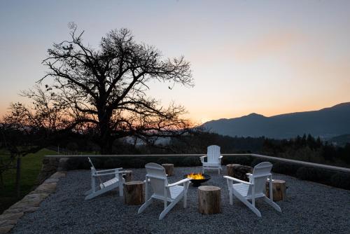 a group of chairs and a fire pit with a sunset at Vinte-Quinta da Boavista in Ponte de Lima