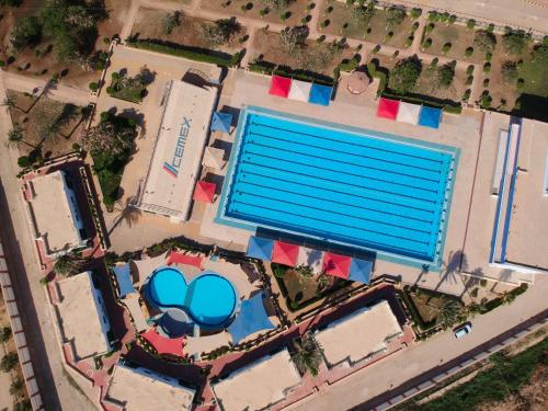 an overhead view of a large swimming pool at Assiut Cement Hotel in Asyut
