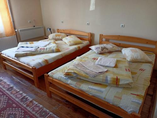 two beds sitting next to each other in a room at Sóhegy Panzió in Praid