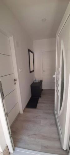 an empty room with a hallway with a washing machine at Apartment Rupena in Klimno