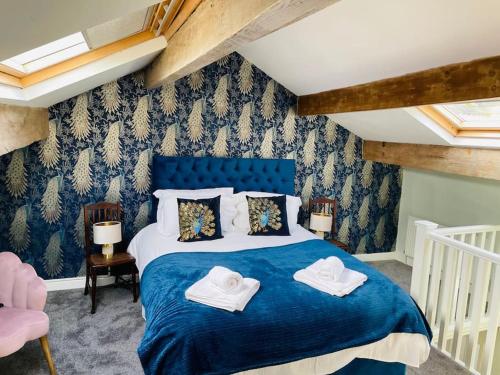 En eller flere senge i et værelse på Tipple Cottage