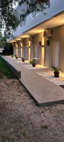 a building with a walkway in front of it at Camping Corali & Apartments in Riza
