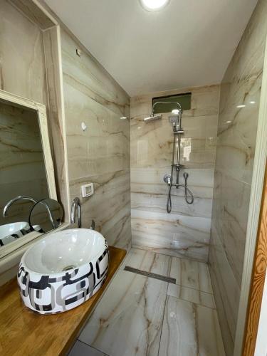 a bathroom with a sink and a shower at Diamond Luxury Apartment - Haifa in Haifa