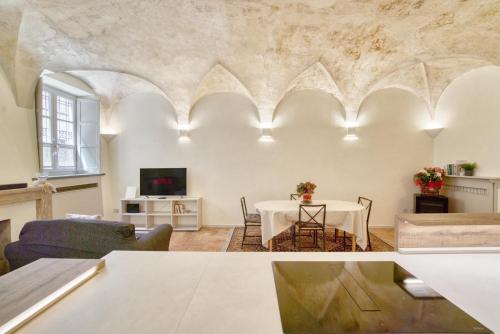 a living room with a table and a tv at Il Loft di Quintino in Parma