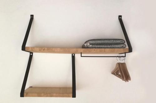 a wooden shelf with a pillow and a broom on it at Cal Calsot Casa Rural "Adults Only" in Montellá