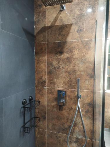 a bathroom with a shower with a glass door at Apartament Leśny-Cedzyna no62 TARGI Kielce Rowery !!! in Kielce