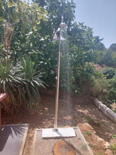 a street light in a garden with a garden sidx sidx sidx at Apartment Rupena in Klimno
