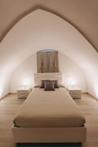 a bedroom with a large bed with two night stands at Suite Matteotti in Fasano