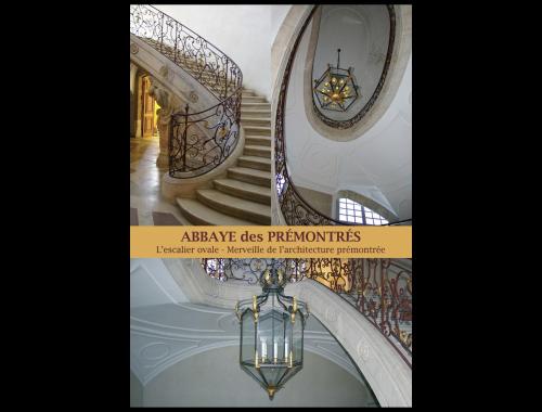a staircase and a chandelier in a building at Hôtel de l'Abbaye des Prémontrés in Pont-à-Mousson