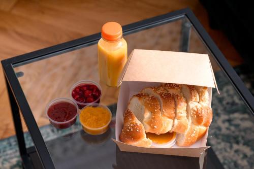 a box of bread and a bottle of orange juice at Native Apartments Rajska 3 in Kraków