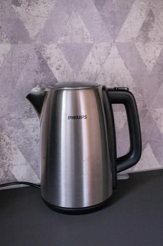 a silver tea kettle sitting on a table at "Haus am Illufer" Ihr Smart-Alpin-Home in Bludenz in Bludenz