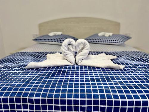 a blue and white bed with towels on it at Casa Munteanu in Mila Douăzeci şi Trei