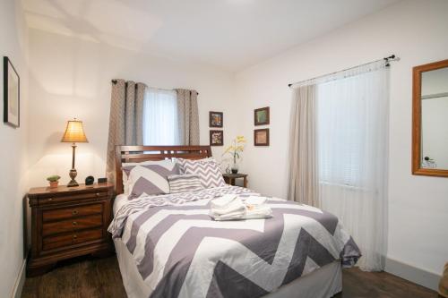 a bedroom with a bed and a dresser and a window at Suite Life at Chez Mercedes in Miami
