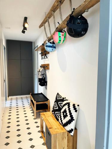 a room with a bench and pots and pans on the wall at Haus Allod 208 in Lenzerheide
