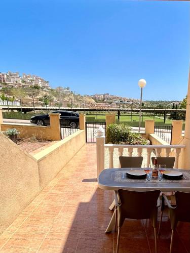 a patio with a table and chairs on a balcony at Tranquil Self Catering Golf Course Apartment in Alicante