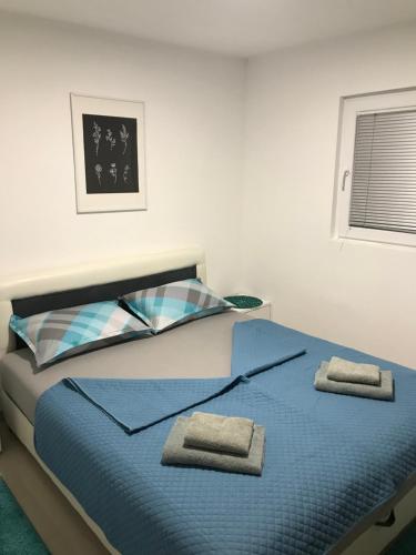 ein Schlafzimmer mit einem Bett, auf dem zwei Handtücher liegen in der Unterkunft Obala Srebrno Jezero in Kisiljevo