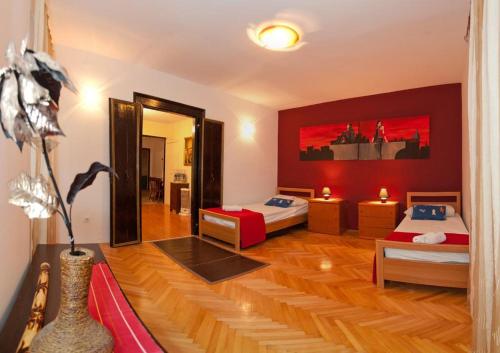 a room with two beds and a mirror at North wall apartment in Split