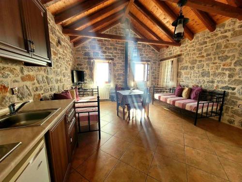 a kitchen and living room with a couch and a table at Althea Village in Areopolis