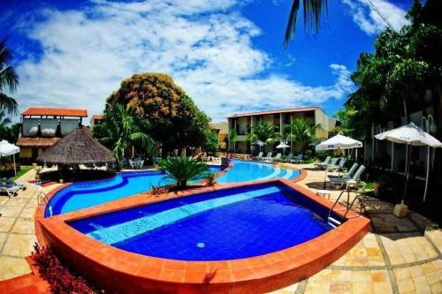a swimming pool at a resort at Solar de Pipa Elegance Flat - Frente Piscina in Pipa