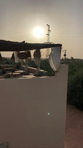 a view of the sun setting over a building at Upupa de l’Atlas in Marrakech