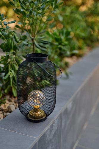 a black vase sitting on top of a wall at Colentum Resort Murter in Murter