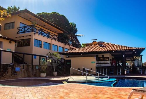 a building with a swimming pool in front of a building at Rio Búzios Beach Hotel in Búzios
