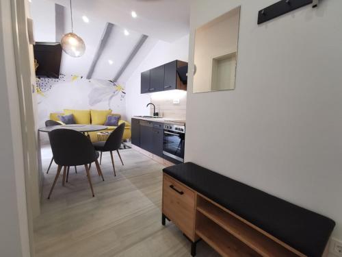 a kitchen and living room with a table and chairs at New Nikolina 4 star in Mali Lošinj