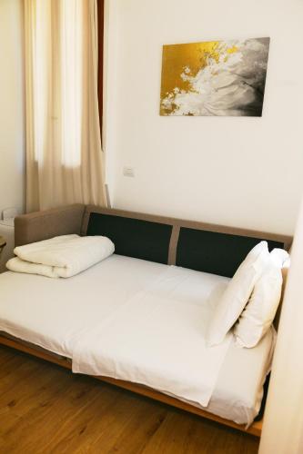 a bed with white sheets and pillows in a room at La Villa bed & breakfast in Milan