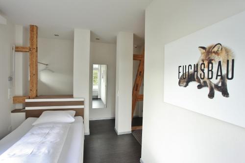 a bedroom with two beds and a painting of a raccoon at Achtender in Metzingen