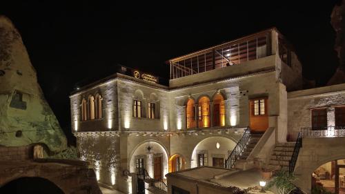 a large building with lights on it at night at Cappadocia Cave Land Hotel in Goreme