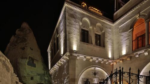 a building with lights on it at night at Cappadocia Cave Land Hotel in Goreme