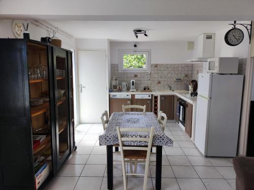 - une cuisine avec une table, une table et des chaises dans l'établissement Appartement Abadie, à Bagnères-de-Bigorre