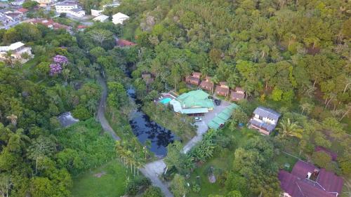 an aerial view of a house with a lake and trees at Pousada Nosso Bosque in Porto Belo