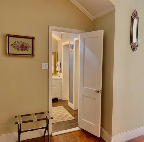 a hallway with a door leading to a bathroom at The Beaumont House Natchez in Natchez
